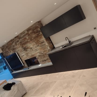 Stone‑clad kitchen with cast concrete worktop